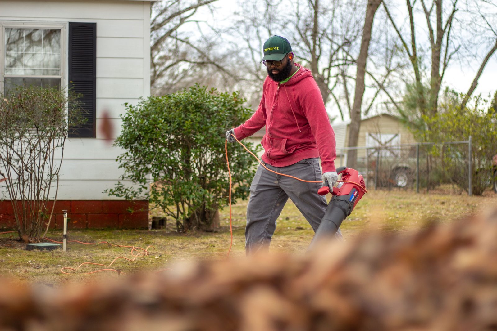 Worker clearing around beds and shrubs
